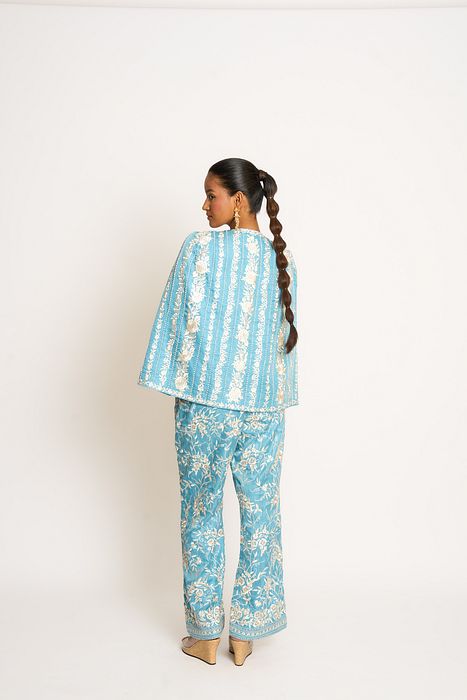 A model showcasing Teapot Blue Giro Cape And Pants Set by Ashtar from Ashtar's collection