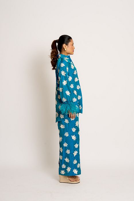 A model showcasing Peacock Blue Shehnaaz Twin Set by Ashtar from Ashtar's collection A model showcasing Peacock Blue Shehnaaz Twin Set by Ashtar from Ashtar's collection