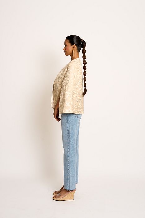 A model showcasing Antique Beige Naina Cape by Ashtar from Ashtar's collection