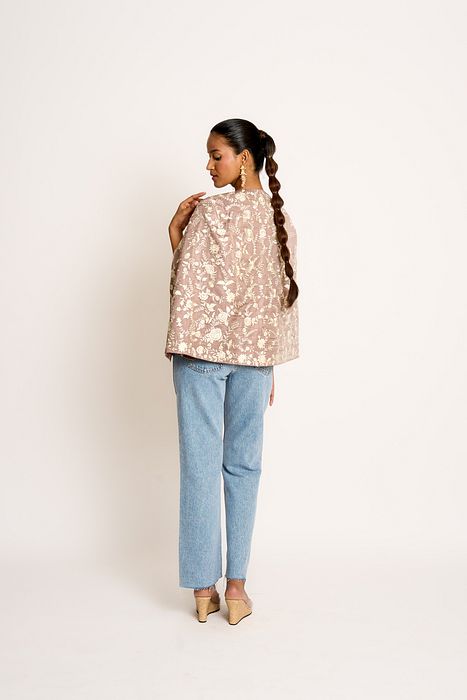 A model showcasing Taupe Grey Naina Cape by Ashtar from Ashtar's collection
