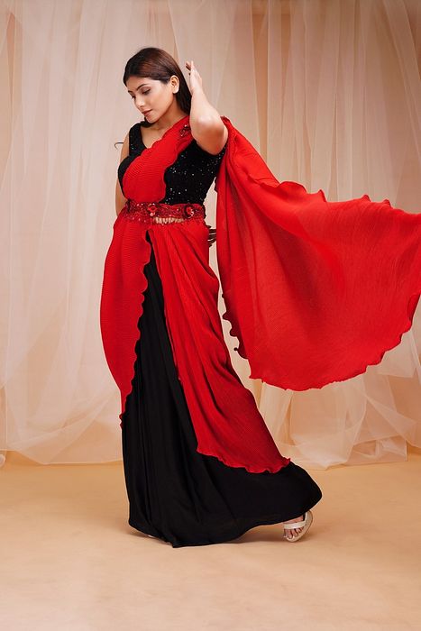 A model showcasing Candy Red Jet Black Ready To Wear Drape Saree by Farha Syed from Farha Syed's collection A model showcasing Candy Red Jet Black Ready To Wear Drape Saree by Farha Syed from Farha Syed's collection