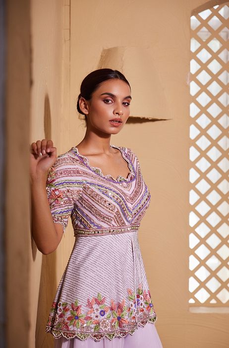 A model showcasing Ishtar Peplum And Sharara Set by Muditaa By Urmila from Muditaa By Urmila's collection