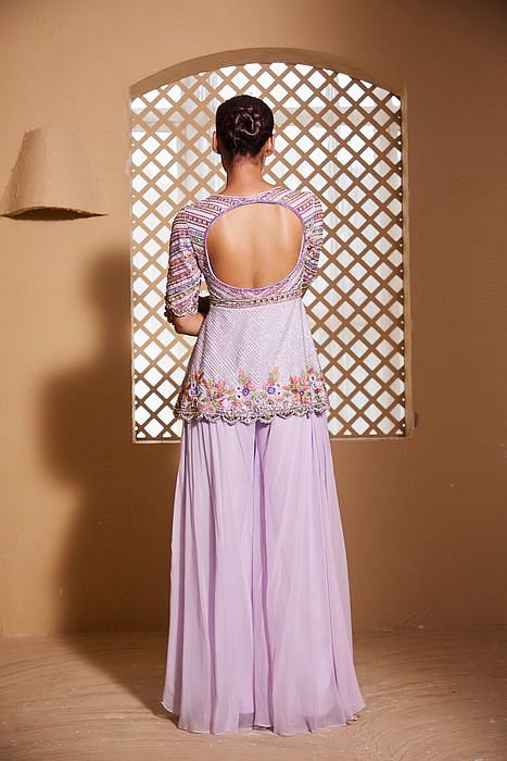 A model showcasing Ishtar Peplum And Sharara Set by Muditaa By Urmila from Muditaa By Urmila's collection