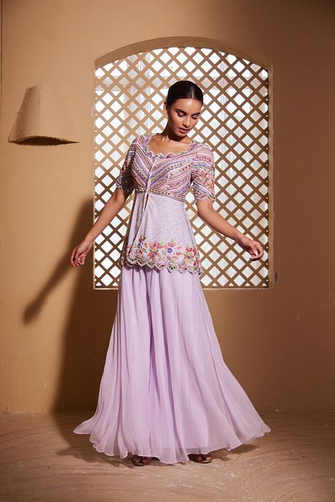 A model showcasing Ishtar Peplum And Sharara Set Feature image by Muditaa By Urmila from Muditaa By Urmila's collection