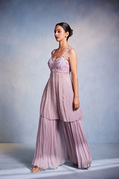 A model showcasing Itisha Peplum And Sharara Set by Muditaa By Urmila from Muditaa By Urmila's collection