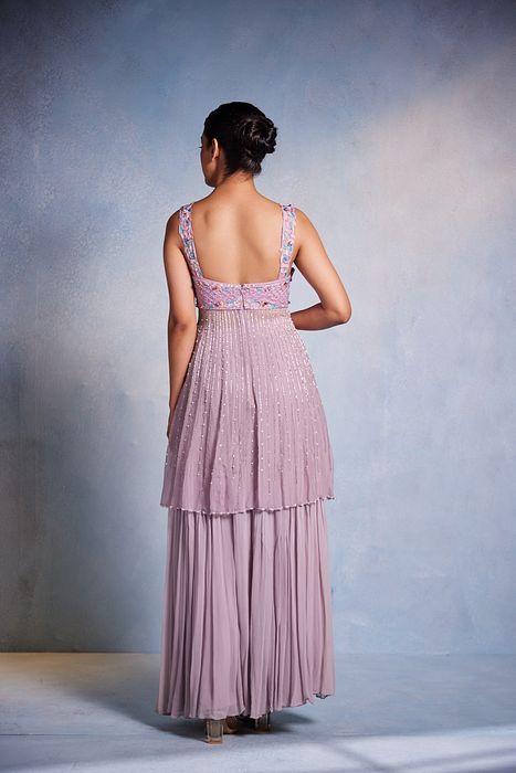 A model showcasing Itisha Peplum And Sharara Set by Muditaa By Urmila from Muditaa By Urmila's collection
