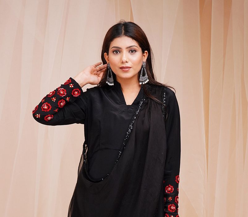 A model showcasing Jet Black Organza Drape Dress by Farha Syed from Farha Syed's collection A model showcasing Jet Black Organza Drape Dress by Farha Syed from Farha Syed's collection