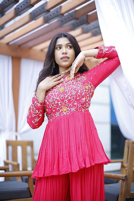 A model showcasing Meher Peplum And Sharara Set by Muditaa By Urmila from Muditaa By Urmila's collection