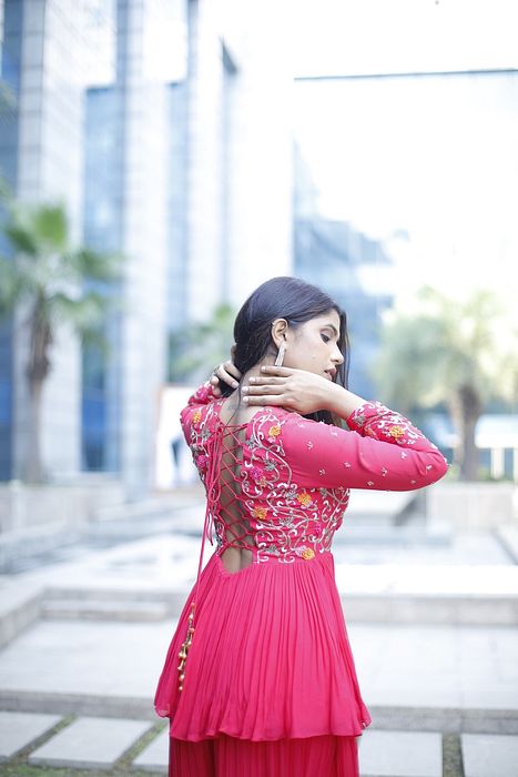 A model showcasing Meher Peplum And Sharara Set by Muditaa By Urmila from Muditaa By Urmila's collection