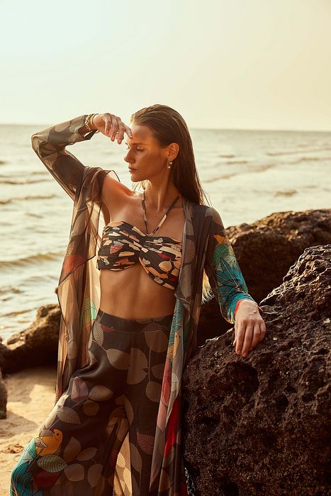 A model showcasing Exotica Cape With Bustier And High Slit Pants by Nautanky from Nautanky's collection