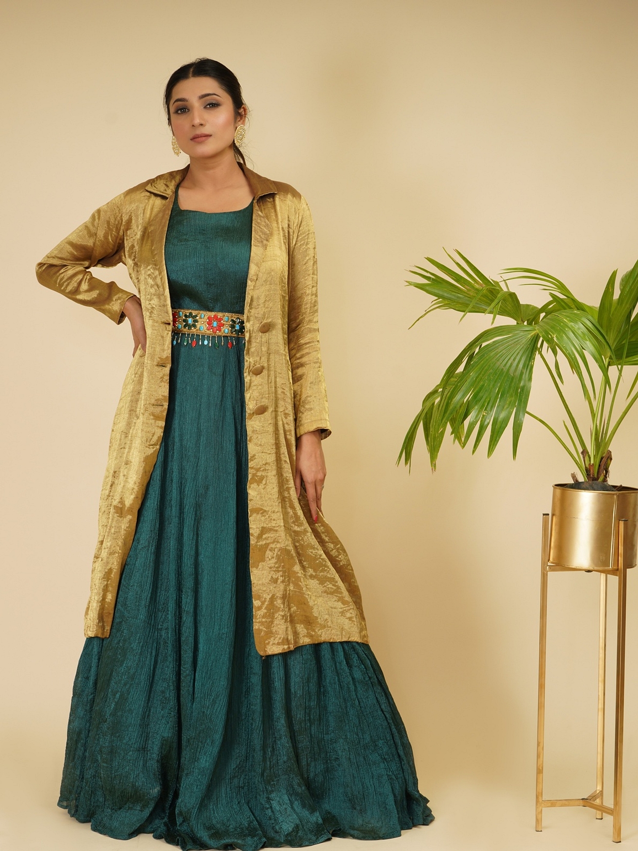 A model showcasing Bottlegreen Gown With Golden Coat Feature image by Farha Syed from Farha Syed's collection