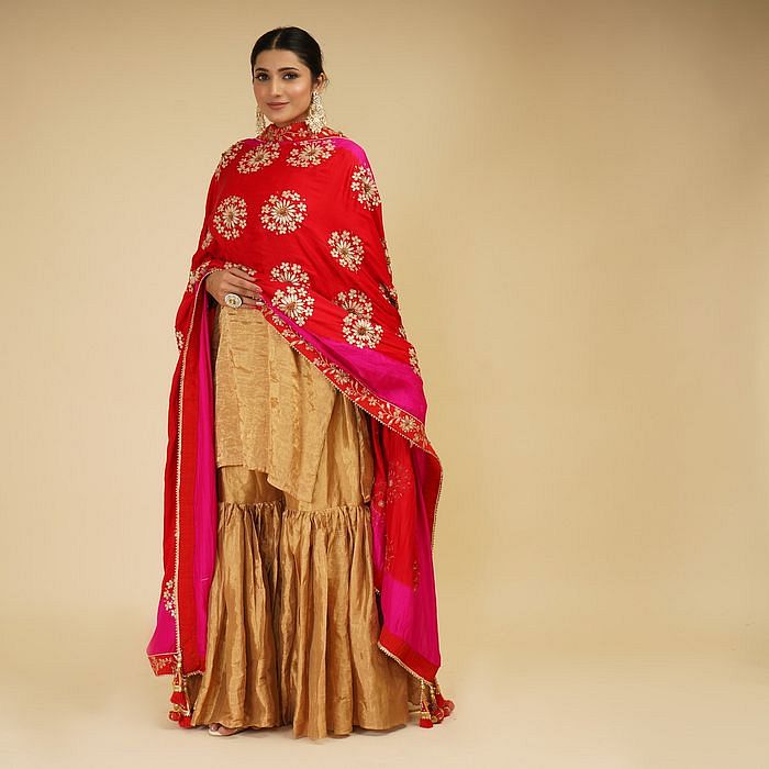 A model showcasing Golden Sharara Set With Pink Red Dupatta by Farha Syed from Farha Syed's collection