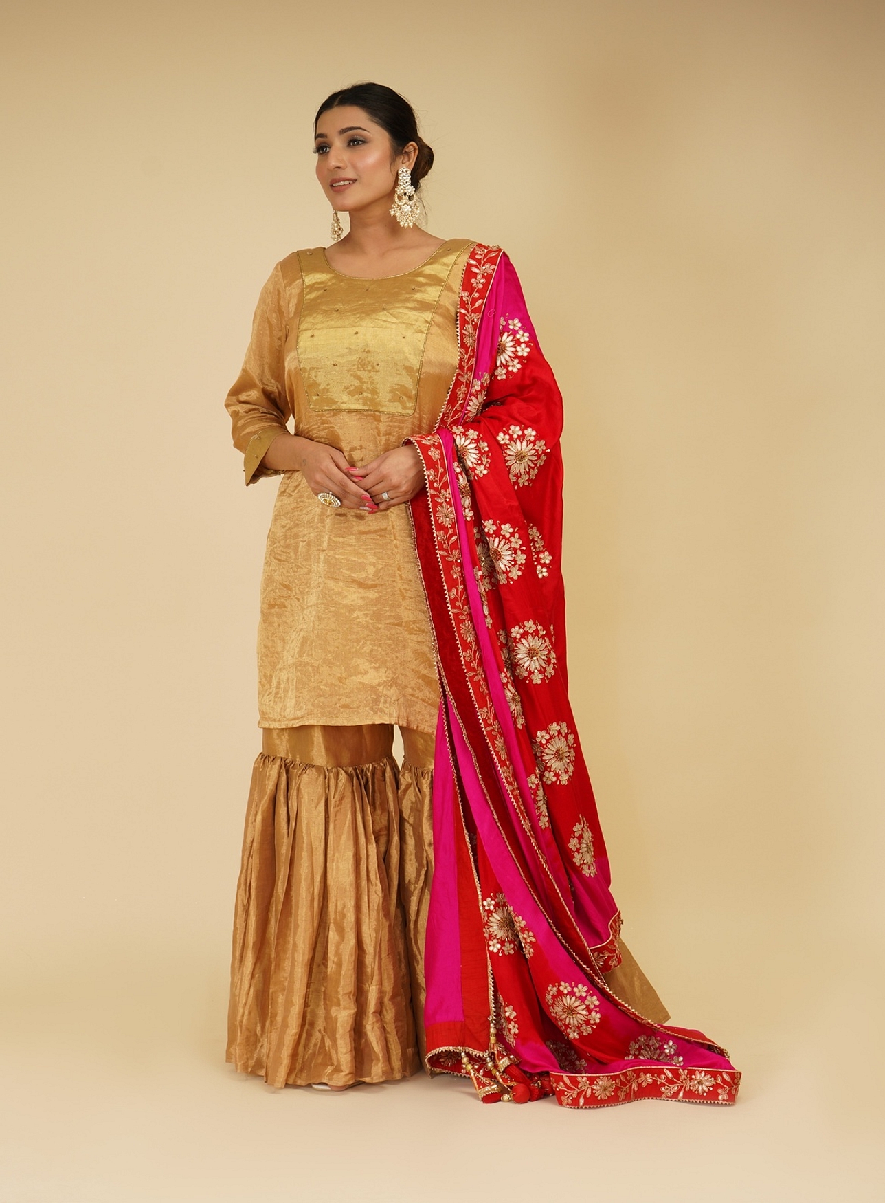 A model showcasing Golden Sharara Set With Pink Red Dupatta Feature image by Farha Syed from Farha Syed's collection