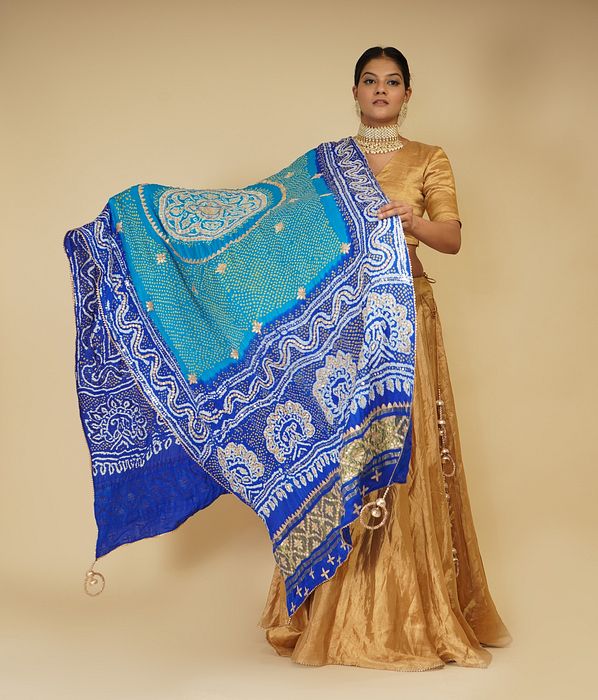 A model showcasing Golden Lehenga Set And Peacock Dupatta by Farha Syed from Farha Syed's collection