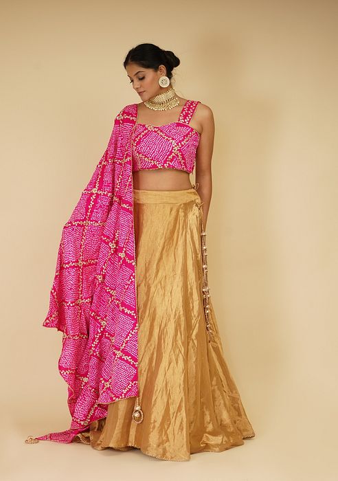 A model showcasing Golden Lehenga Set With Pink Dupatta by Farha Syed from Farha Syed's collection