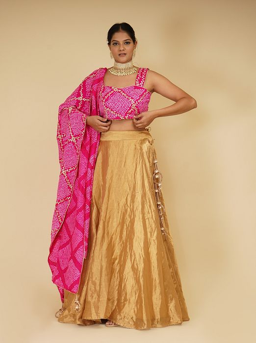 A model showcasing Golden Lehenga Set With Pink Dupatta by Farha Syed from Farha Syed's collection