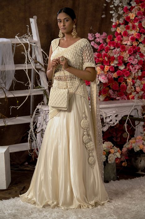 A model showcasing Ivory Lehenga Set With Handbag by Farha Syed from Farha Syed's collection
