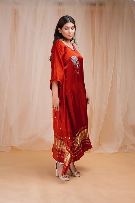 A model showcasing Rust Red Kaftan by Farha Syed from Farha Syed's collection A model showcasing Rust Red Kaftan by Farha Syed from Farha Syed's collection
