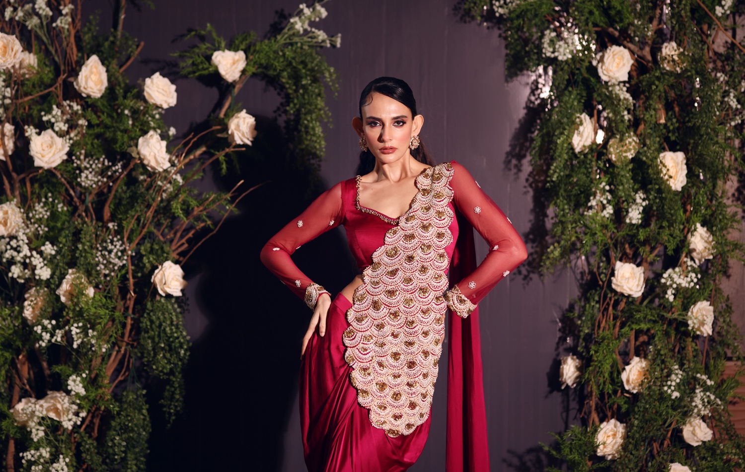 A model showcasing Fuschia Red Drape Saree by Ayushi Agarwal from Ayushi Agarwal's collection