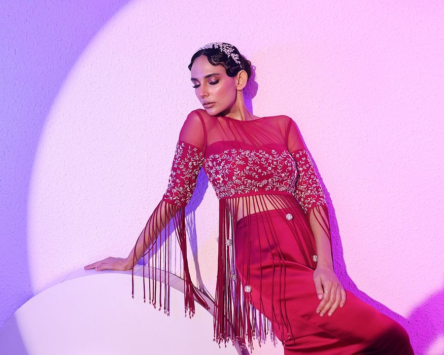 A model showcasing Fuschia Top And Skirt Set by Ayushi Agarwal from Ayushi Agarwal's collection
