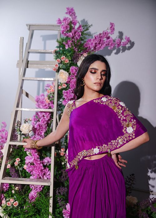 A model showcasing Purple Drape Skirt And Top Set by Ayushi Agarwal from Ayushi Agarwal's collection