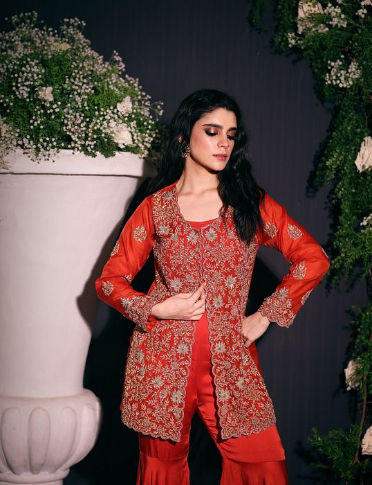 A model showcasing Rust Jacket With Sharara by Ayushi Agarwal from Ayushi Agarwal's collection
