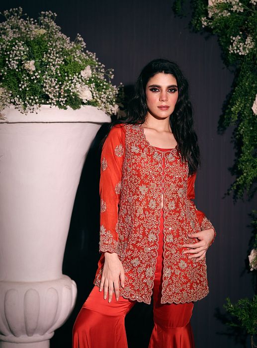 A model showcasing Rust Jacket With Sharara by Ayushi Agarwal from Ayushi Agarwal's collection