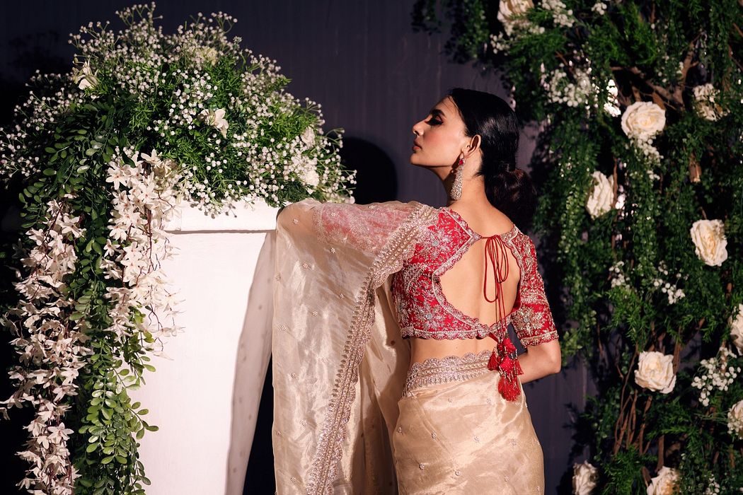 A model showcasing Red And Gold Organza Saree by Ayushi Agarwal from Ayushi Agarwal's collection