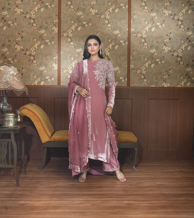 A model showcasing Zia Pink Velvet Suit Set by Ayushi Agarwal from Ayushi Agarwal's collection