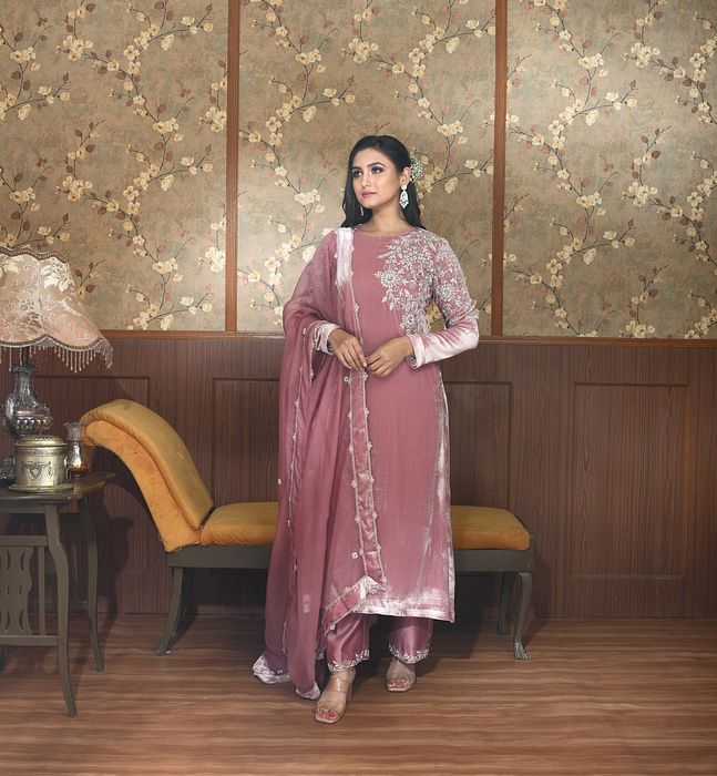 A model showcasing Zia Pink Velvet Suit Set by Ayushi Agarwal from Ayushi Agarwal's collection