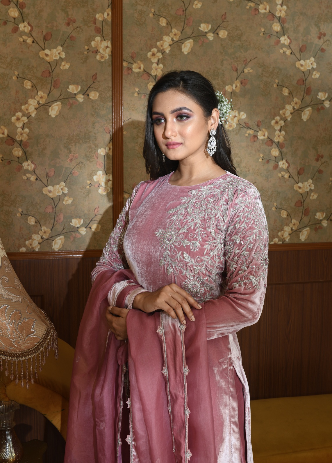 A model showcasing Zia Pink Velvet Suit Set by Ayushi Agarwal from Ayushi Agarwal's collection