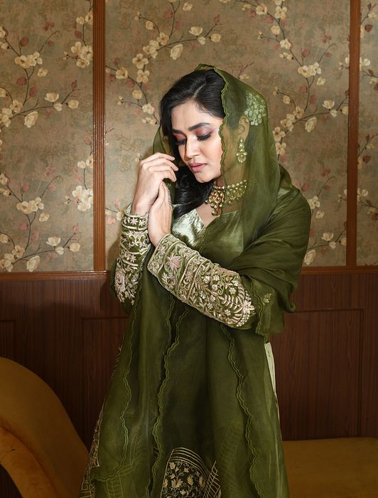 A model showcasing Green Inara Velvet Suit Set by Ayushi Agarwal from Ayushi Agarwal's collection A model showcasing Green Inara Velvet Suit Set by Ayushi Agarwal from Ayushi Agarwal's collection