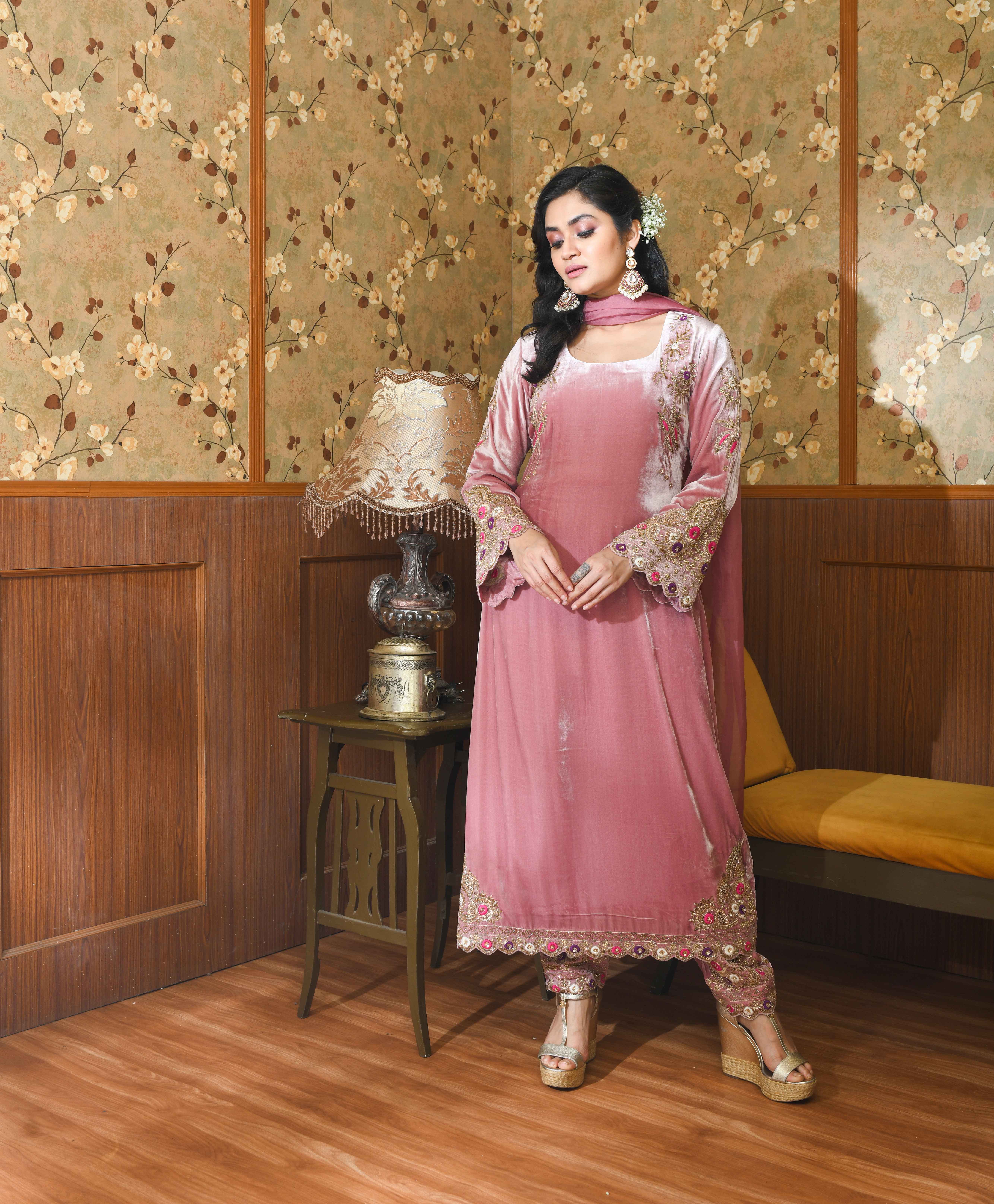 A model showcasing Pink Gul Velvet Suit Set by Ayushi Agarwal from Ayushi Agarwal's collection