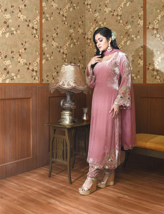 A model showcasing Pink Gul Velvet Suit Set by Ayushi Agarwal from Ayushi Agarwal's collection