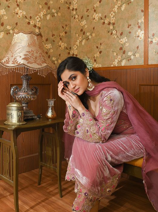 A model showcasing Pink Gul Velvet Suit Set by Ayushi Agarwal from Ayushi Agarwal's collection