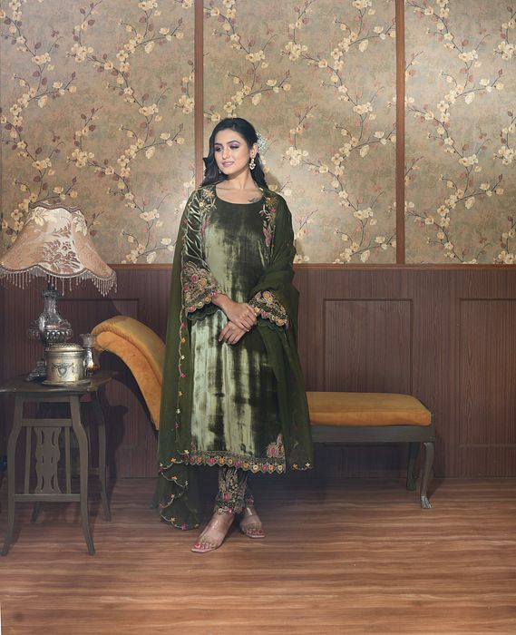 A model showcasing Green Gul Velvet Suit Set by Ayushi Agarwal from Ayushi Agarwal's collection