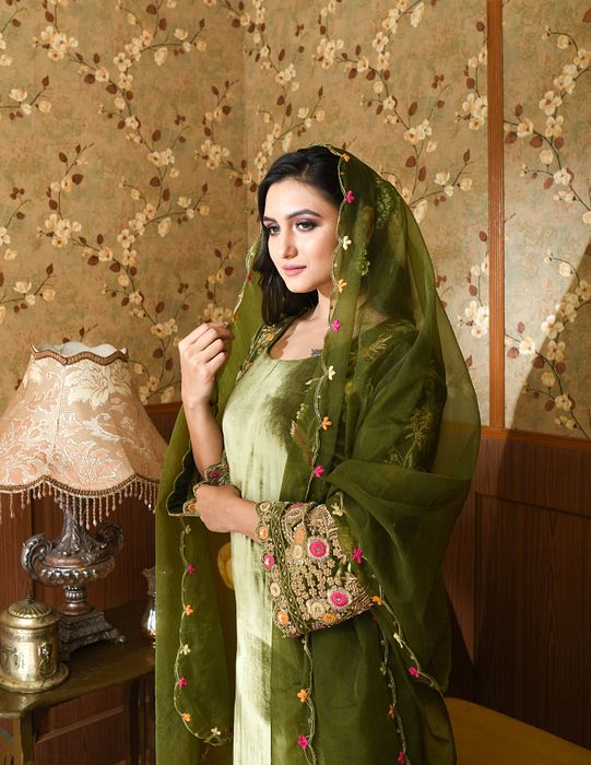 A model showcasing Green Gul Velvet Suit Set by Ayushi Agarwal from Ayushi Agarwal's collection