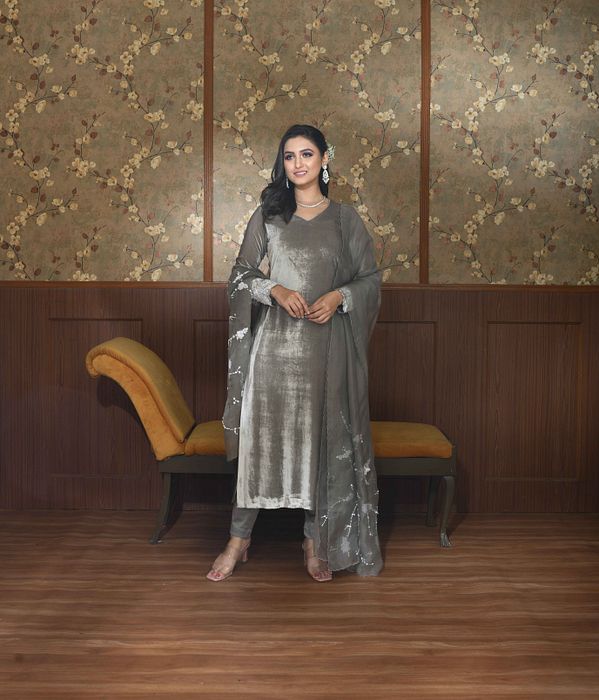 A model showcasing Grey Ella Velvet Suit Set by Ayushi Agarwal from Ayushi Agarwal's collection A model showcasing Grey Ella Velvet Suit Set by Ayushi Agarwal from Ayushi Agarwal's collection