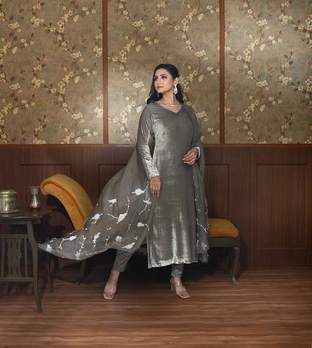 A model showcasing Grey Ella Velvet Suit Set by Ayushi Agarwal from Ayushi Agarwal's collection A model showcasing Grey Ella Velvet Suit Set by Ayushi Agarwal from Ayushi Agarwal's collection