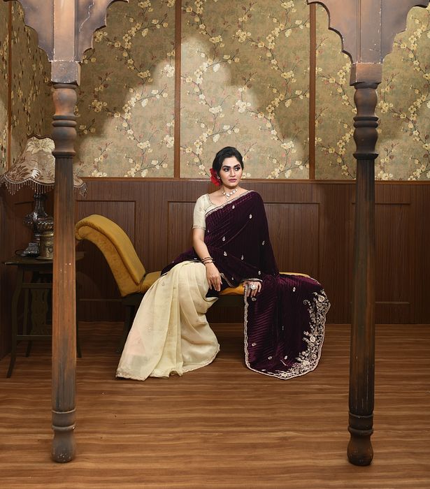 A model showcasing Kira Gold And Magenta Velvet Saree by Ayushi Agarwal from Ayushi Agarwal's collection A model showcasing Kira Gold And Magenta Velvet Saree by Ayushi Agarwal from Ayushi Agarwal's collection