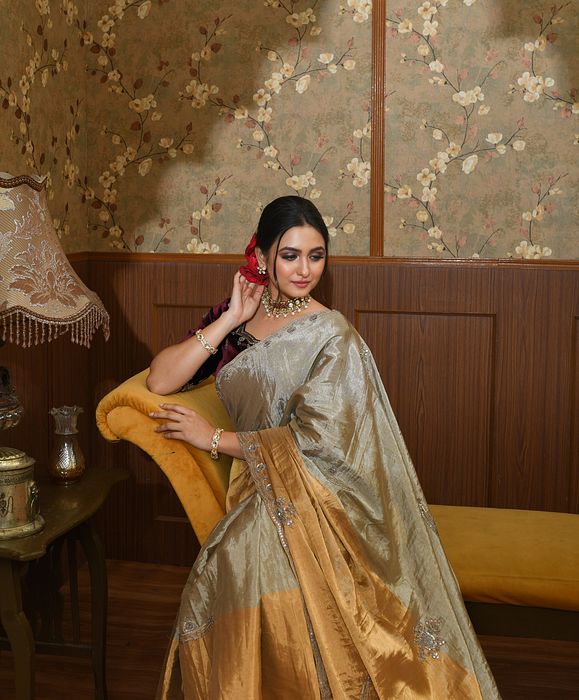 A model showcasing Inara Gold And Silver Metallic Saree by Ayushi Agarwal from Ayushi Agarwal's collection