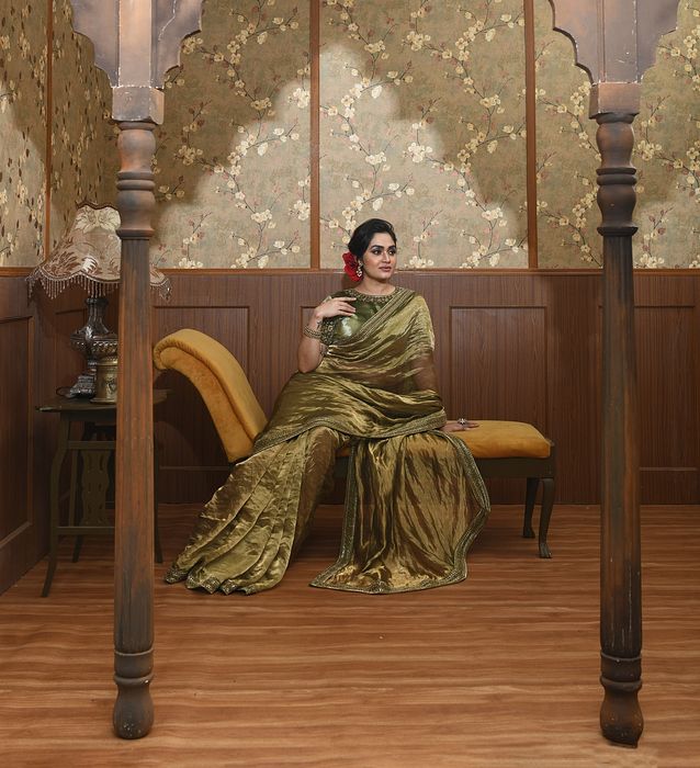 A model showcasing Aisha Green Saree by Ayushi Agarwal from Ayushi Agarwal's collection A model showcasing Aisha Green Saree by Ayushi Agarwal from Ayushi Agarwal's collection