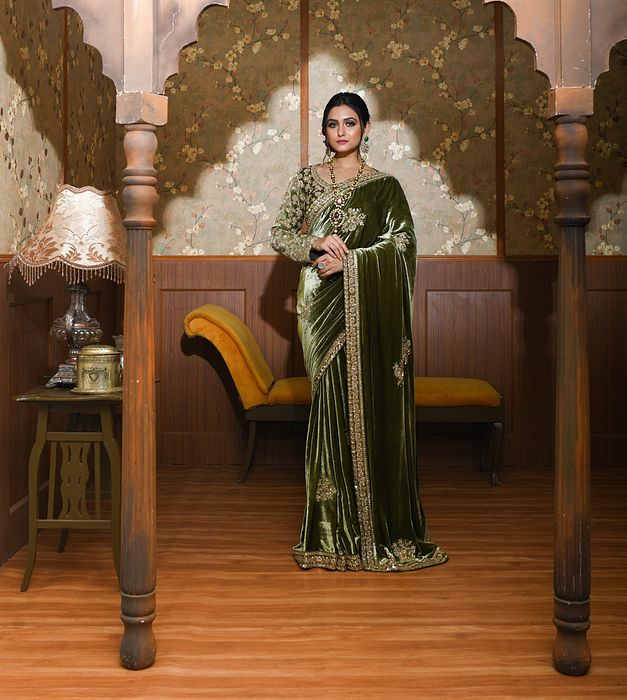 A model showcasing Adya Green Velvet Saree by Ayushi Agarwal from Ayushi Agarwal's collection
