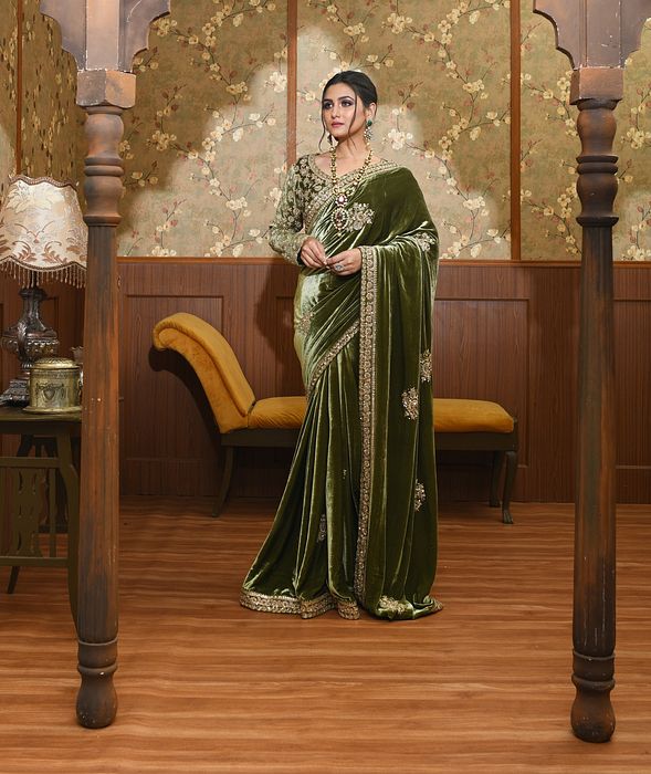 A model showcasing Adya Green Velvet Saree by Ayushi Agarwal from Ayushi Agarwal's collection