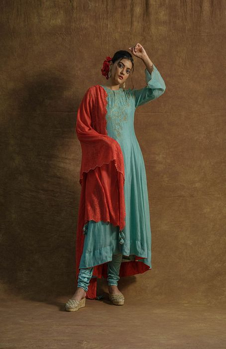 A model showcasing Mint Green Anarkali Set With Chudidaar And Dupatta by Farha Syed from Farha Syed's collection A model showcasing Mint Green Anarkali Set With Chudidaar And Dupatta by Farha Syed from Farha Syed's collection