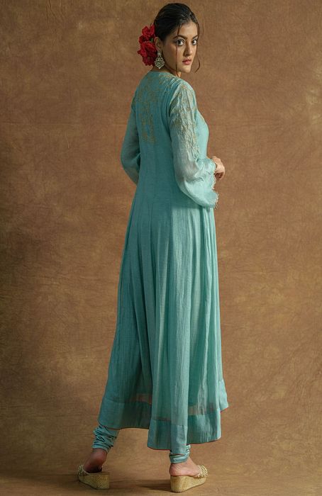 A model showcasing Mint Green Anarkali Set With Chudidaar And Dupatta by Farha Syed from Farha Syed's collection A model showcasing Mint Green Anarkali Set With Chudidaar And Dupatta by Farha Syed from Farha Syed's collection