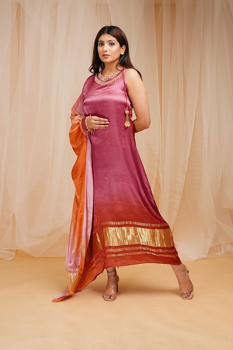 A model showcasing Mulberry Violet Orangutan Orange Shaded Kaftaan by Farha Syed from Farha Syed's collection A model showcasing Mulberry Violet Orangutan Orange Shaded Kaftaan by Farha Syed from Farha Syed's collection
