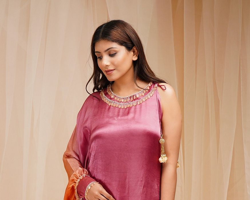 A model showcasing Mulberry Violet Orangutan Orange Shaded Kaftaan by Farha Syed from Farha Syed's collection A model showcasing Mulberry Violet Orangutan Orange Shaded Kaftaan by Farha Syed from Farha Syed's collection