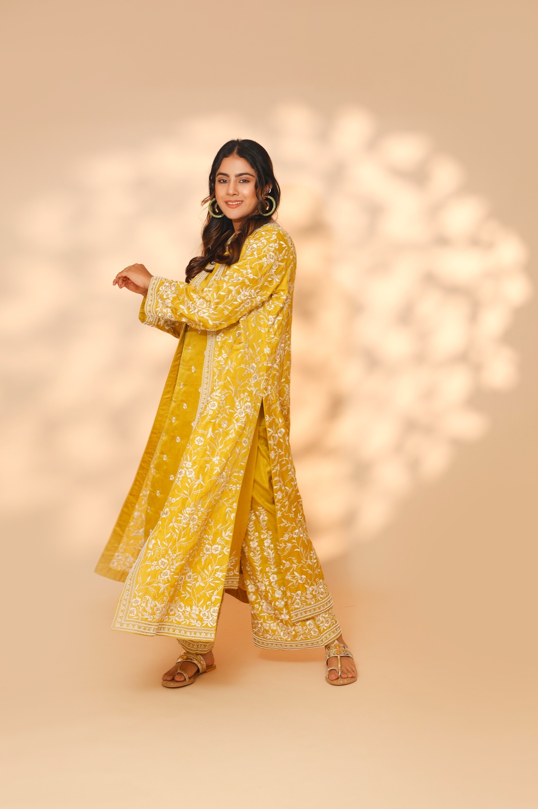 A model showcasing Yellow Daffodil Long Jacket Kurta Set by Ashtar from Ashtar's collection A model showcasing Yellow Daffodil Long Jacket Kurta Set by Ashtar from Ashtar's collection