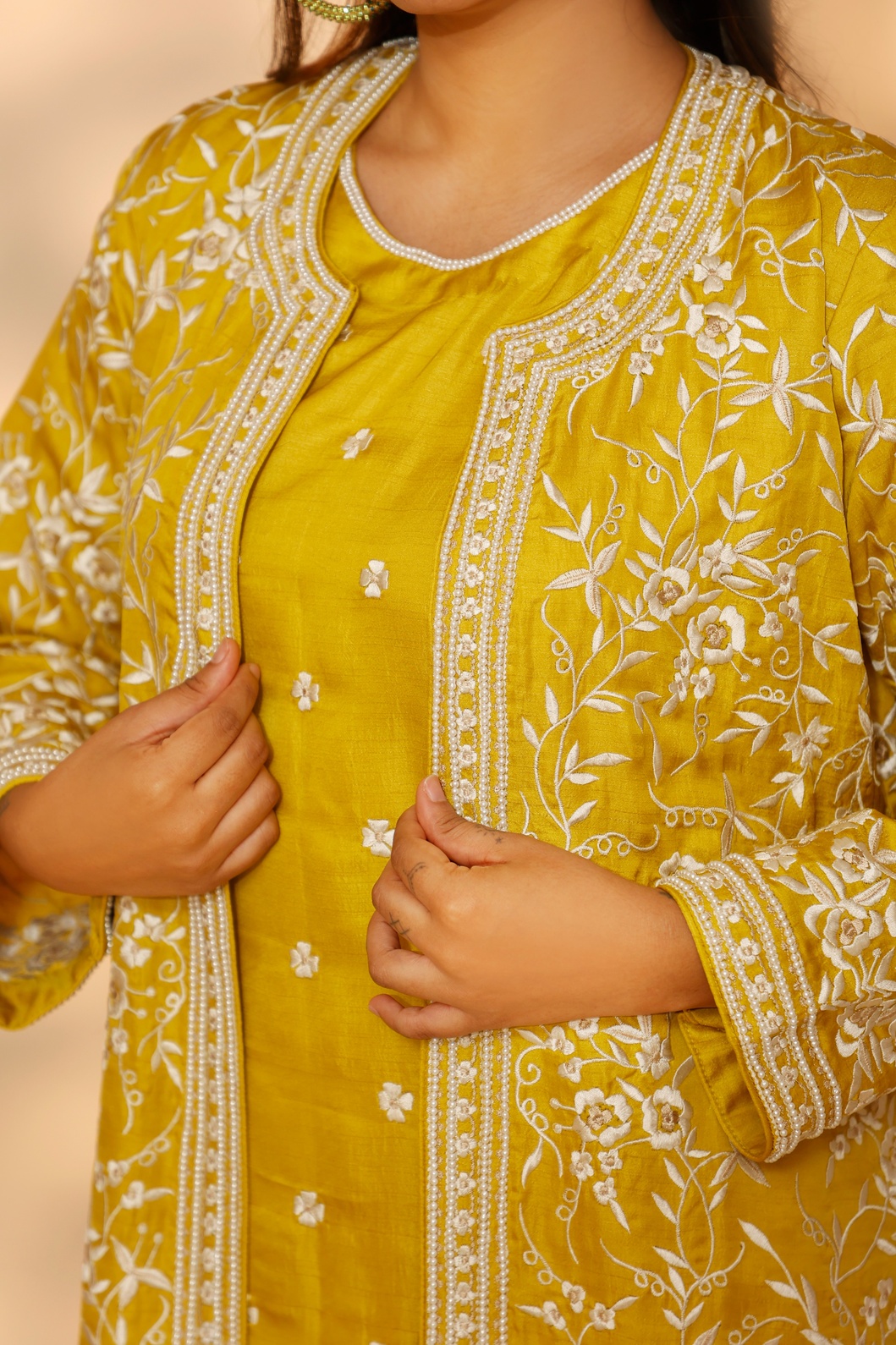 A model showcasing Yellow Daffodil Long Jacket Kurta Set by Ashtar from Ashtar's collection A model showcasing Yellow Daffodil Long Jacket Kurta Set by Ashtar from Ashtar's collection